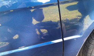 This is picture of a car door before being polished with Buff pro. it is grimy and dirty.