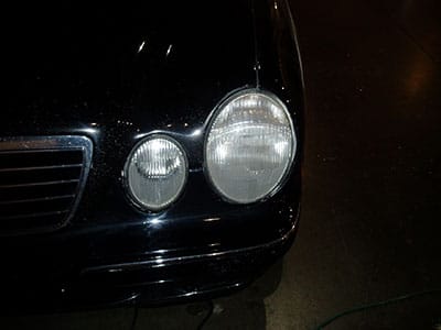 This is a picture of headlights on a black car that ahve been cleaned with Buff pro. They are clean and shiny.
